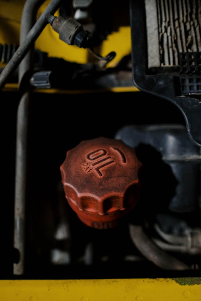 why-choose-us Detailed view of a red oil cap on machinery, emphasizing industrial design.